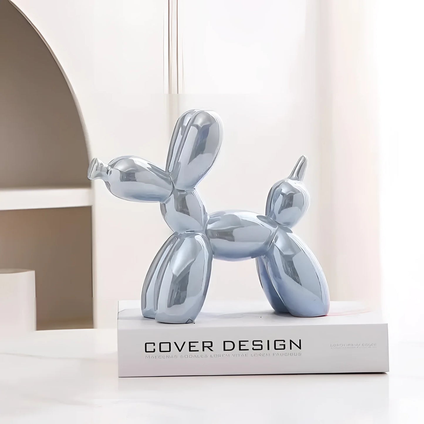 A pearl blue balloon dog sculpture made of metallic material, showcasing a contemporary art design with a reflective surface.
