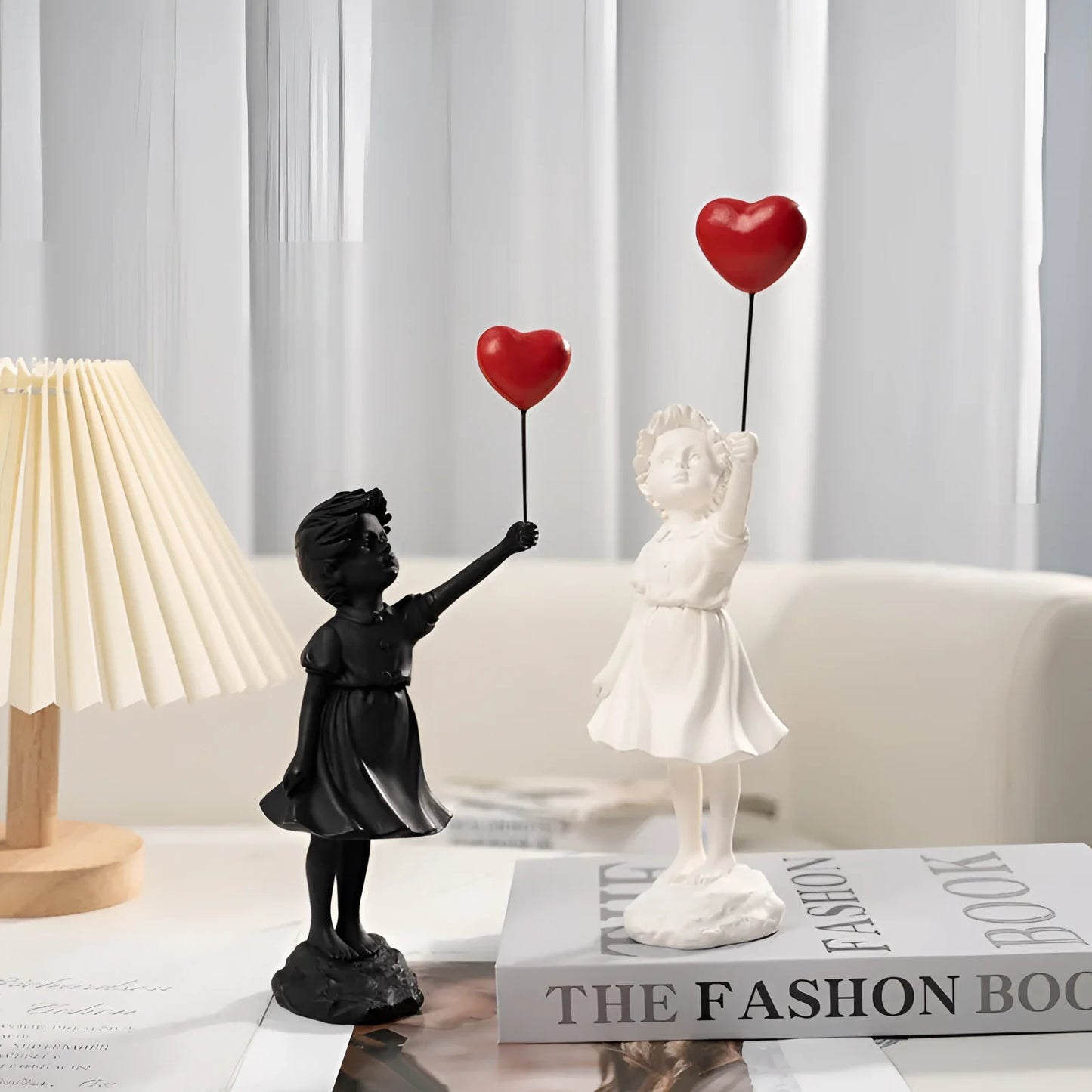 Balloon Girl Resin Statuette featuring a girl in a dress with an outstretched arm, inspired by urban art. The statuette captures a playful and joyful gesture, suitable for display on a table as part of modern décor.