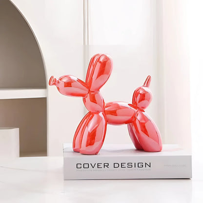 Orange balloon dog sculpture with a metallic finish, designed as contemporary art decor.