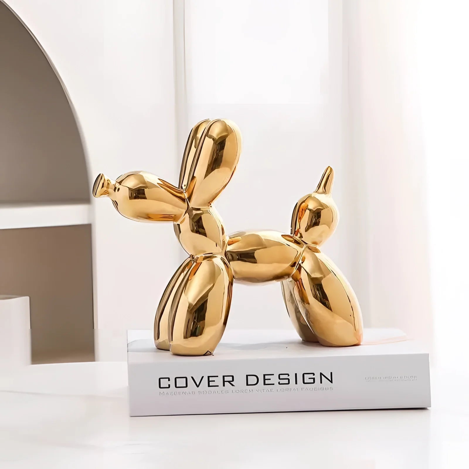 Gold balloon dog sculpture in a metallic finish, serving as contemporary art decor.